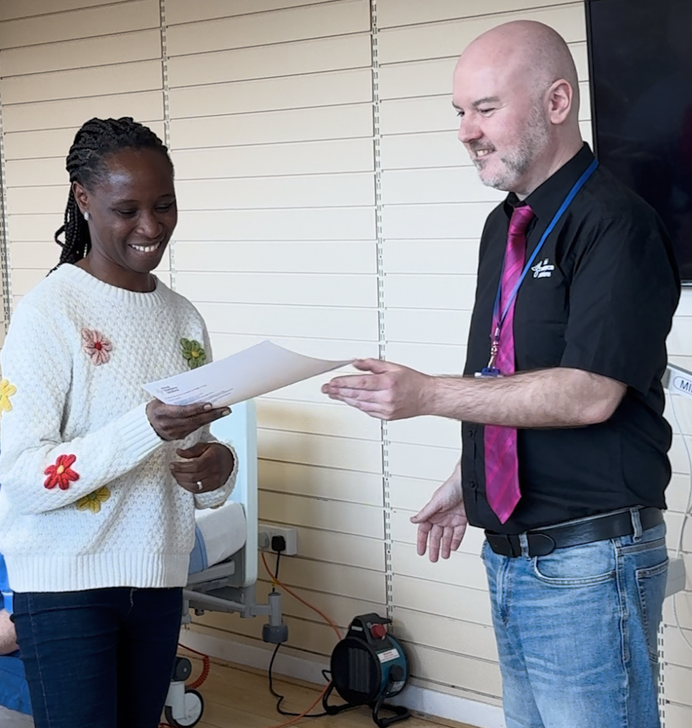Learner being presented their all wales passport certificate from Ash Nelson - Director at Ethical workforce Solutions